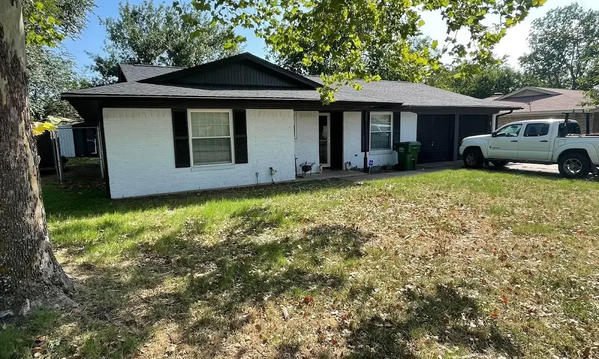 Professional roofing crew working on a residential roof in Sparta